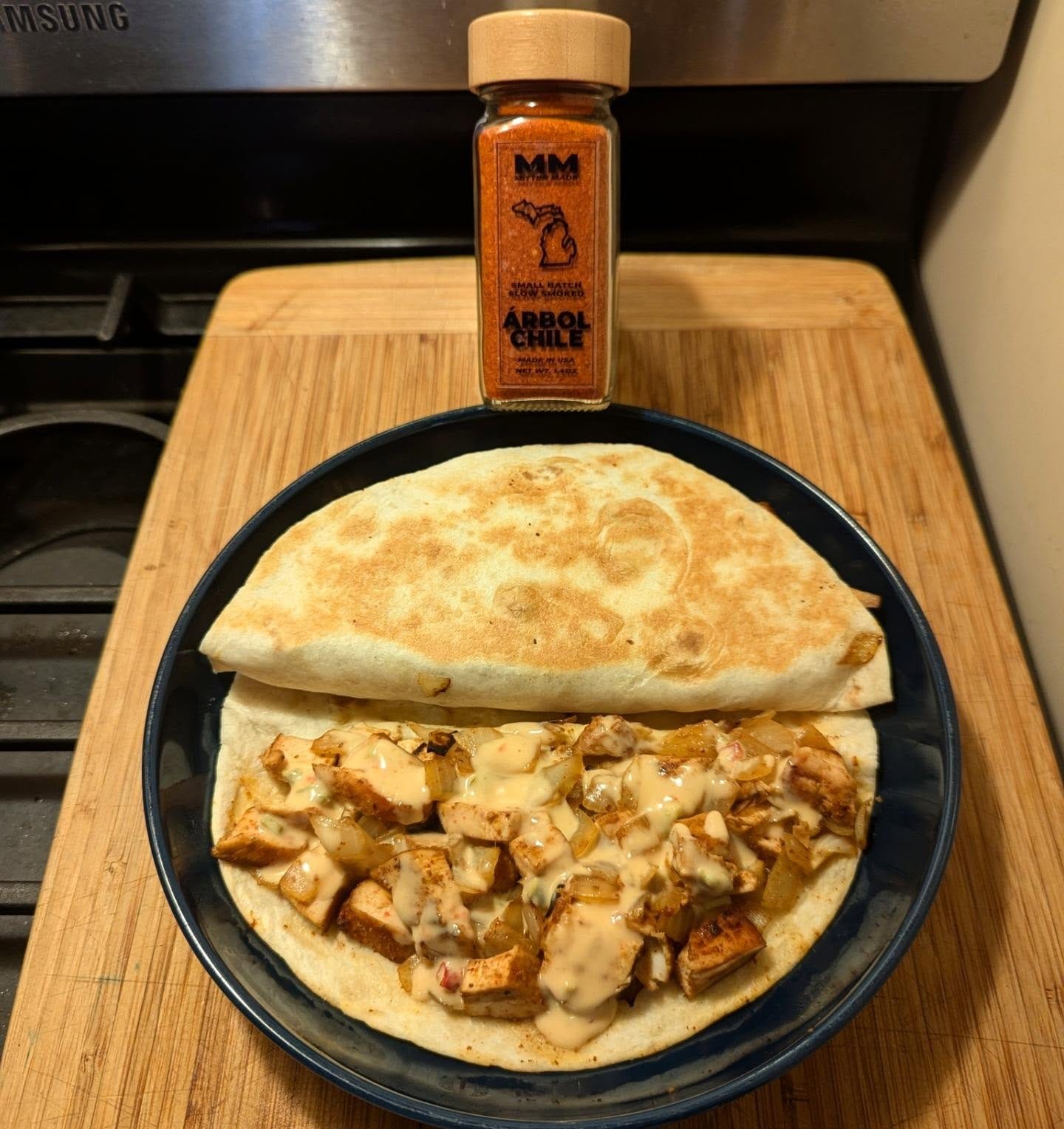 a 10 minute meal, Spicy Smoked Chicken quesadilla with sauteed onions & queso
